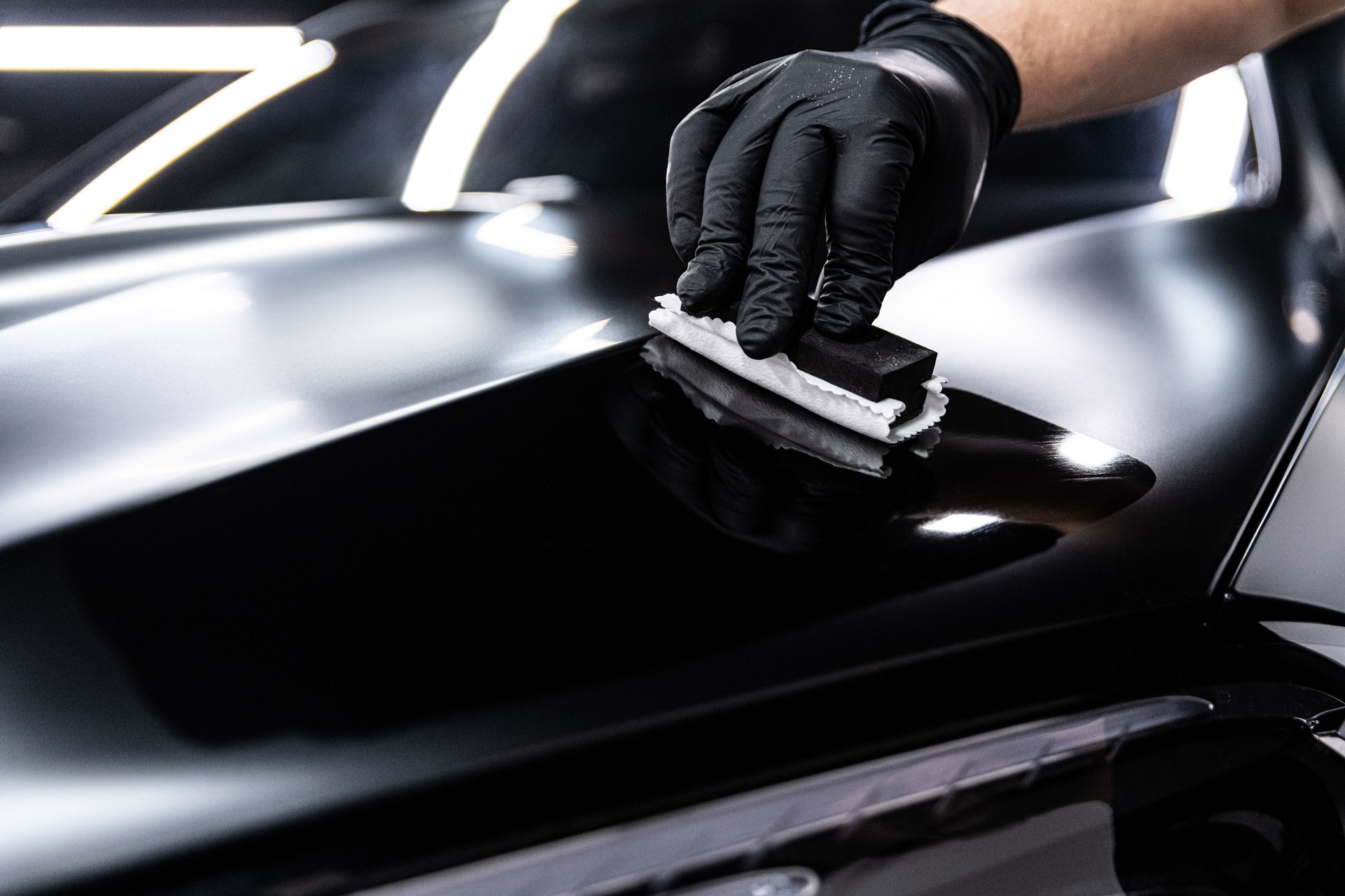 Car wash employee applies ceramic or graphene coating
